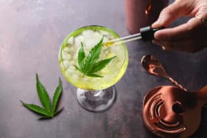 Delicious cannabis margarita cocktail tail topped with a cannabis leaf and a drop of marijuana CBD tincture. Kickstart your relaxation and enjoy medical cannabis differently.