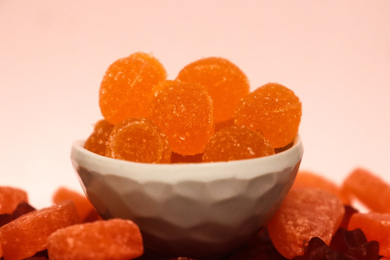Orange flavored strawberry shaped jelly in a bowl